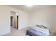 Clean, carpeted bedroom with a queen bed, neutral walls and trim, and light-filled doorway at 7651 Fenn Way, Fort Mill, SC 29707