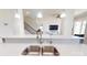 The kitchen has stainless steel sink, quartz countertops, and is open to other rooms at 7651 Fenn Way, Fort Mill, SC 29707