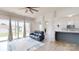 Open-concept living room with hardwood floors, view to the kitchen, and sliding doors to the patio at 7651 Fenn Way, Fort Mill, SC 29707