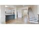 Open-concept living space with wood floors, a view of the kitchen, and a staircase to the second floor at 7651 Fenn Way, Fort Mill, SC 29707