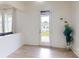 Well-lit room with hardwood floors, rear access door, and view to the backyard at 7651 Fenn Way, Fort Mill, SC 29707
