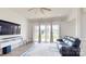 Bright living room with wood floors, modern entertainment center, and sliding glass doors to the backyard at 7651 Fenn Way, Fort Mill, SC 29707