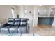 Spacious living room with a comfortable leather sofa, hardwood floors, and an adjacent kitchen area at 7651 Fenn Way, Fort Mill, SC 29707