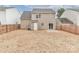 View of the home's rear exterior with a fenced yard, door to the outside, and sliding glass door to patio at 7806 Mcgarry Trl, Charlotte, NC 28214