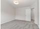 Neutrally decorated bedroom with a modern light fixture and door to the hallway at 7806 Mcgarry Trl, Charlotte, NC 28214