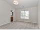 Bedroom with neutral carpet, a window, and a view into the adjoining bathroom at 7806 Mcgarry Trl, Charlotte, NC 28214