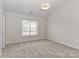 Bright bedroom with a window, neutral carpet, and modern ceiling light at 7806 Mcgarry Trl, Charlotte, NC 28214