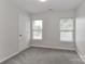 An empty bedroom with neutral walls, carpet, and windows to allow natural light at 7806 Mcgarry Trl, Charlotte, NC 28214