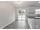 Eat-in kitchen area with wood floors, a view of the backyard and access to outside at 7806 Mcgarry Trl, Charlotte, NC 28214