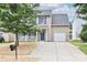 Charming two-story home with a well-maintained yard, attached garage, and a welcoming front porch at 7806 Mcgarry Trl, Charlotte, NC 28214