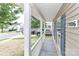 Inviting covered front porch with white railings and views of the front yard at 7806 Mcgarry Trl, Charlotte, NC 28214
