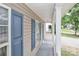 Inviting covered front porch with white railings and blue shutters at 7806 Mcgarry Trl, Charlotte, NC 28214