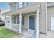 Inviting covered front porch with white railings and a blue front door at 7806 Mcgarry Trl, Charlotte, NC 28214