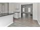 Bright, open kitchen featuring modern cabinets, black countertops, and views into the living room at 7806 Mcgarry Trl, Charlotte, NC 28214