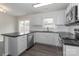 Modern kitchen featuring stainless steel appliances, granite countertops, and white cabinetry at 7806 Mcgarry Trl, Charlotte, NC 28214