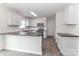 Modern kitchen with a large island, stainless steel appliances, and stylish white cabinetry at 7806 Mcgarry Trl, Charlotte, NC 28214