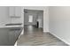 Bright, open kitchen featuring modern cabinets, black countertops, and views into the living room at 7806 Mcgarry Trl, Charlotte, NC 28214