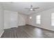 Bright living room featuring wood floors, a ceiling fan, and natural light from the windows at 7806 Mcgarry Trl, Charlotte, NC 28214
