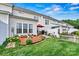 Lush backyard with a well-manicured lawn, flower beds, and a cozy patio area for outdoor relaxation and enjoyment at 8002 Mariners Pointe Cir, Denver, NC 28037