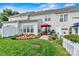 Charming backyard featuring a well-maintained lawn, landscaped garden beds, patio with umbrella, and outdoor seating at 8002 Mariners Pointe Cir, Denver, NC 28037