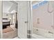 Bathroom and bedroom, showing white doors, shower curtain and a large bed at 8002 Mariners Pointe Cir, Denver, NC 28037