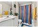 Bathroom with shower, vanity, mirror, decor, towels, toilet, and blue shower curtain at 8002 Mariners Pointe Cir, Denver, NC 28037