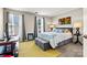 This bedroom is staged with a bed, lamps, decor, rug, curtains and large windows at 8002 Mariners Pointe Cir, Denver, NC 28037