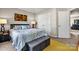 This bedroom features a bed, night stand, 2 closets, rug, lamp and artwork at 8002 Mariners Pointe Cir, Denver, NC 28037