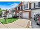 Attractive townhome with a brick front, tidy landscaping, and a convenient one-car garage at 8002 Mariners Pointe Cir, Denver, NC 28037