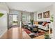 Bright living room with hardwood floors, natural light, and comfortable seating arrangement at 8002 Mariners Pointe Cir, Denver, NC 28037