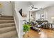 The living room has a cozy fireplace, hardwood floors and modern decor at 8002 Mariners Pointe Cir, Denver, NC 28037