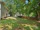 Lush backyard showcasing mature trees, a green lawn, and a serene outdoor environment at 8030 Glencannon Dr, Charlotte, NC 28227