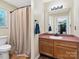 Bathroom featuring shower with curtain and functional vanity with sink and ample lighting at 8030 Glencannon Dr, Charlotte, NC 28227