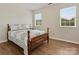 Bedroom with wood-look floors and two windows letting in natural light at 8030 Glencannon Dr, Charlotte, NC 28227