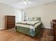 Bedroom with ceiling fan, hardwood floors, a double bed, and a dresser at 8030 Glencannon Dr, Charlotte, NC 28227