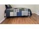 Bedroom with wood-look floors and a patchwork quilt on the bed at 8030 Glencannon Dr, Charlotte, NC 28227