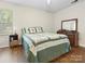 Comfortable bedroom featuring wood floors, a ceiling fan, and a cozy quilt on the bed at 8030 Glencannon Dr, Charlotte, NC 28227