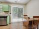 Bright dining area with a sliding glass door to the backyard and a wood table at 8030 Glencannon Dr, Charlotte, NC 28227
