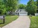Beautiful two-story home boasting a two-car garage, lush green lawn, and established trees at 8030 Glencannon Dr, Charlotte, NC 28227