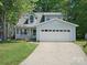 Charming two-story home features a large garage, landscaped front yard, and welcoming front porch at 8030 Glencannon Dr, Charlotte, NC 28227