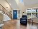 Bright living room with a blue front door, stairs to the second floor, and a window at 8030 Glencannon Dr, Charlotte, NC 28227