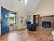 Cozy living room featuring hardwood floors, a brick fireplace, and ample natural light at 8030 Glencannon Dr, Charlotte, NC 28227