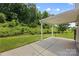 Covered patio with backyard featuring lush greenery and a storage shed at 8400 Empress Ct, Charlotte, NC 28227