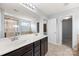 Modern bathroom featuring a double sink vanity, glass enclosed shower, and neutral tile flooring at 8400 Empress Ct, Charlotte, NC 28227