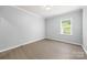 A bright bedroom with wood-look floors and a window letting in natural light at 8400 Empress Ct, Charlotte, NC 28227