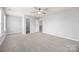 Neutral bedroom featuring a ceiling fan, walk-in closet, plush carpet and easy access to a private bath at 8400 Empress Ct, Charlotte, NC 28227