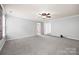 Open bedroom with plush carpet, ceiling fan, and doorways to the bathroom and closet at 8400 Empress Ct, Charlotte, NC 28227