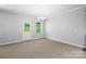 Bright dining area with backyard access, complemented by a modern chandelier at 8400 Empress Ct, Charlotte, NC 28227