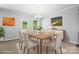 Bright dining room with wood table, stylish chandelier, large window, and modern buffet at 8400 Empress Ct, Charlotte, NC 28227