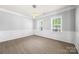 Bright dining room showcasing wood floors, trim, and modern lighting at 8400 Empress Ct, Charlotte, NC 28227